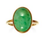 A JADEITE JADE DRESS RING in high carat yellow gold set with an oval jade cabochon, unmarked, size M