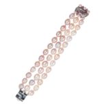 A THREE ROW PINK PEARL AND PINK SAPPHIRE BRACELET in 18ct white gold, comprising three rows of