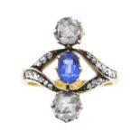 AN ANTIQUE SAPPHIRE AND DIAMOND THREE STONE RING in yellow gold, set with an oval cut sapphire and