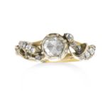 AN ANTIQUE DIAMOND RING in high carat yellow gold and silver set with a central rose cut diamond