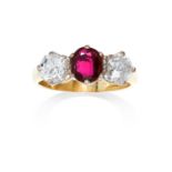 A RUBY AND DIAMOND THREE STONE RING in 18ct yellow and white gold, the oval cut ruby between round