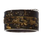 AN ANTIQUE JAPANESE SHAKUDO BANGLE in gold and silver, featuring high relief decoration depicting