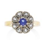 A SAPPHIRE AND DIAMOND RING in high carat yellow gold and silver set with a round cut sapphire of