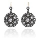 A PAIR OF ANTIQUE DIAMOND CLUSTER EARRINGS in yellow gold and silver, each set with a circular