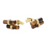 A PAIR OF VINTAGE TIGER'S EYE CUFFLINKS in 18ct yellow gold, each designed with two polished