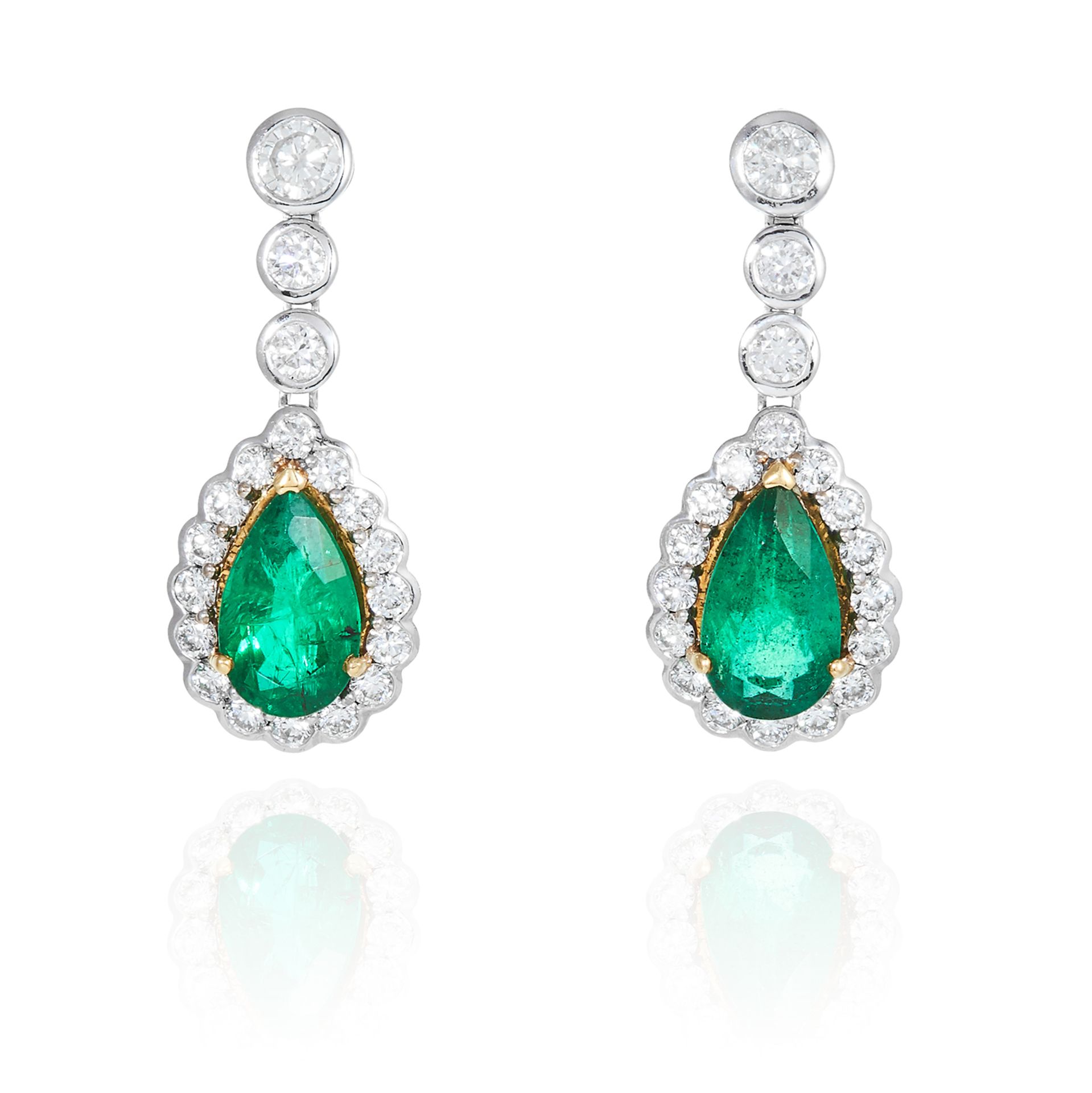 A PAIR OF EMERALD AND DIAMOND EARRINGS in 18ct white gold, each set with a pear cut emerald