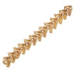 A FANCY LINK GOLD AND DIAMOND BRACELET, CIRCA 1950, French, comprising of thirteen fancy circular