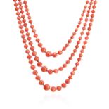 AN ANTIQUE THREE ROW CORAL BEAD NECKLACE in yellow gold comprising three rows of two hundred and