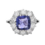 A SAPPHIRE AND DIAMOND DRESS RING in 18ct white gold, the 3.81 carat cushion cut purple sapphire