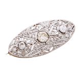 AN ART DECO DIAMOND BROOCH in yellow gold and platinum the oval face jewelled with three principal