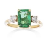 AN EMERALD AND DIAMOND DRESS RING in high carat yellow gold, set with a central emerald of 1.82