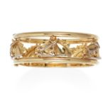 A VINTAGE EQUESTRIAN HORSE BANGLE in 18ct yellow gold, designed with five horses heads set between