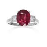 A 4.38 CARAT RUBY AND DIAMOND RING in platinum, set with an oval cut ruby of 4.38 carats between