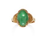 A JADEITE JADE RING in high carat yellow gold, set with an oval jade cabochon between foliate