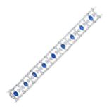 AN ART DECO SAPPHIRE AND DIAMOND BRACELET in platinum, set with a row of nine oval cut sapphires