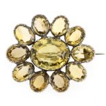 AN ANTIQUE CITRINE BROOCH, 19TH CENTURY in silver, set with a cluster of oval cut citrines,
