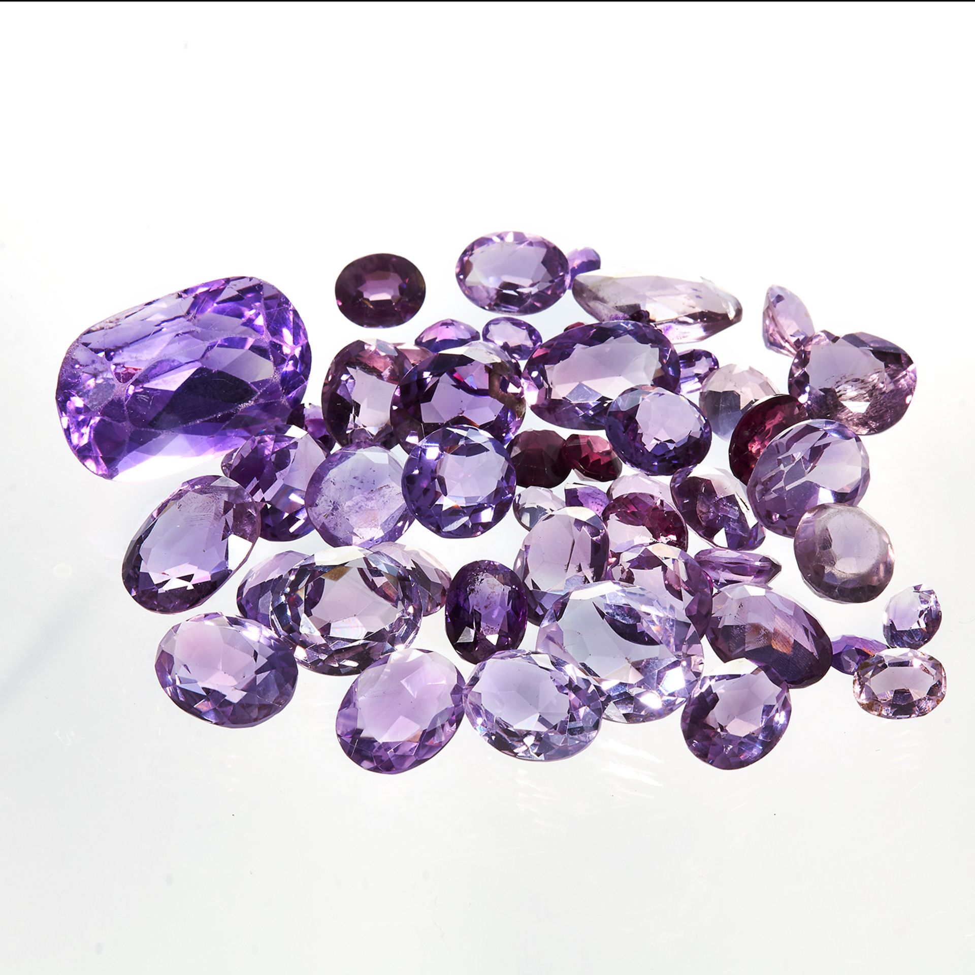 A 192 CARAT PARCEL OF AMETHYSTS variously sized up to 37.40 carats, mostly round and oval faceted,