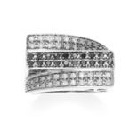 A BLACK AND WHITE DIAMOND DRESS RING in 9ct white gold, the twisted band set with three rows of