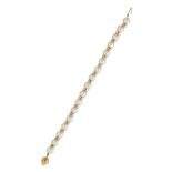 A PEARL AND DIAMOND BRACELET in 18ct yellow gold, comprising a single row of pearls with spacers, on