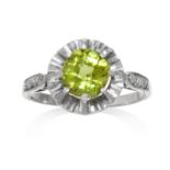 AN ART DECO PERIDOT AND DIAMOND RING in gold or platinum, set with a central faceted peridot,