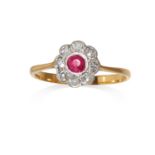 AN ANTIQUE RUBY AND DIAMOND CLUSTER RING in 18ct gold, the round cut ruby encircled by eight