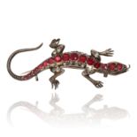 A SILVER AND PASTE LIZARD BROOCH in silver, set with fourteen red jewels to the body and further