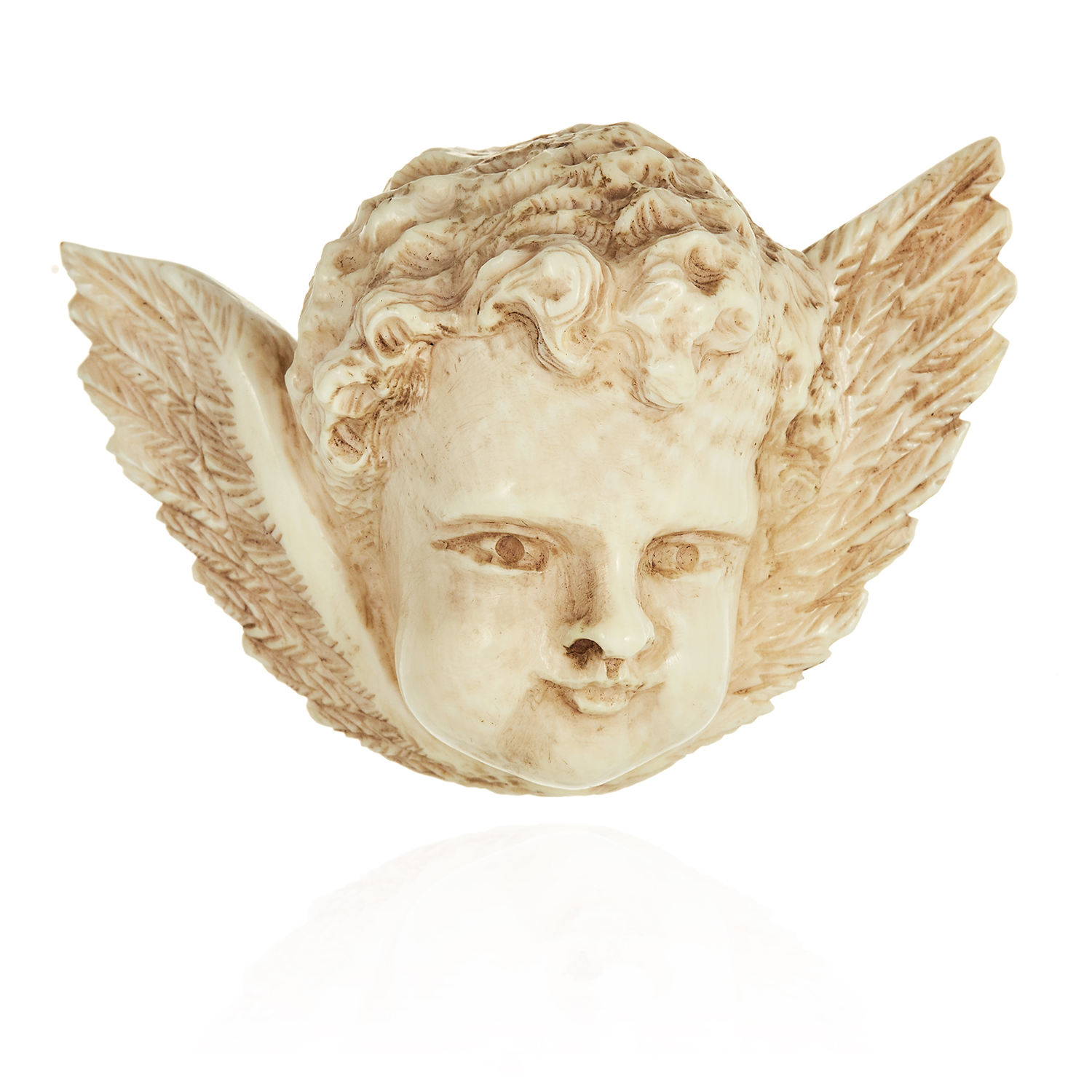 AN ANTIQUE CARVED IVORY CHERUB BROOCH, 19TH CENTURY, formed of a cherub's face with wings, 6.2cm,