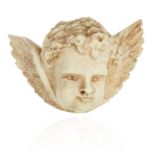 AN ANTIQUE CARVED IVORY CHERUB BROOCH, 19TH CENTURY, formed of a cherub's face with wings, 6.2cm,