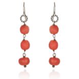 A PAIR OF ANTIQUE CARVED CORAL BEAD EARRINGS in sterling silver, each jewelled with three carved