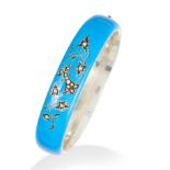 A PEARL AND ENAMEL BANGLE in silver, comprising of blue enamel and jewelled with seed pearls in