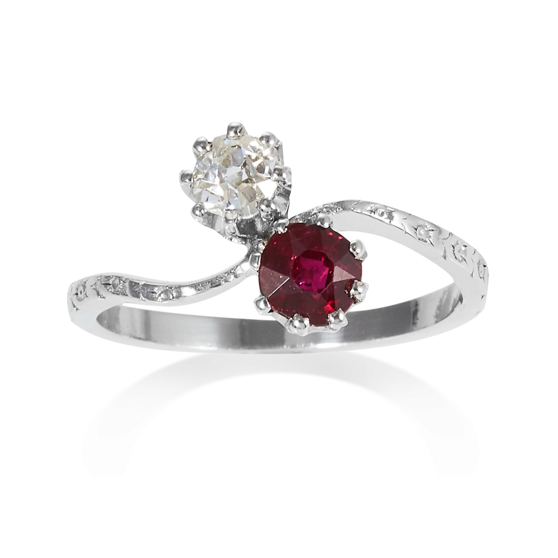 A RUBY AND DIAMOND TOI ET MOI RING in platinum, set with a round cut ruby of approximately 0.60