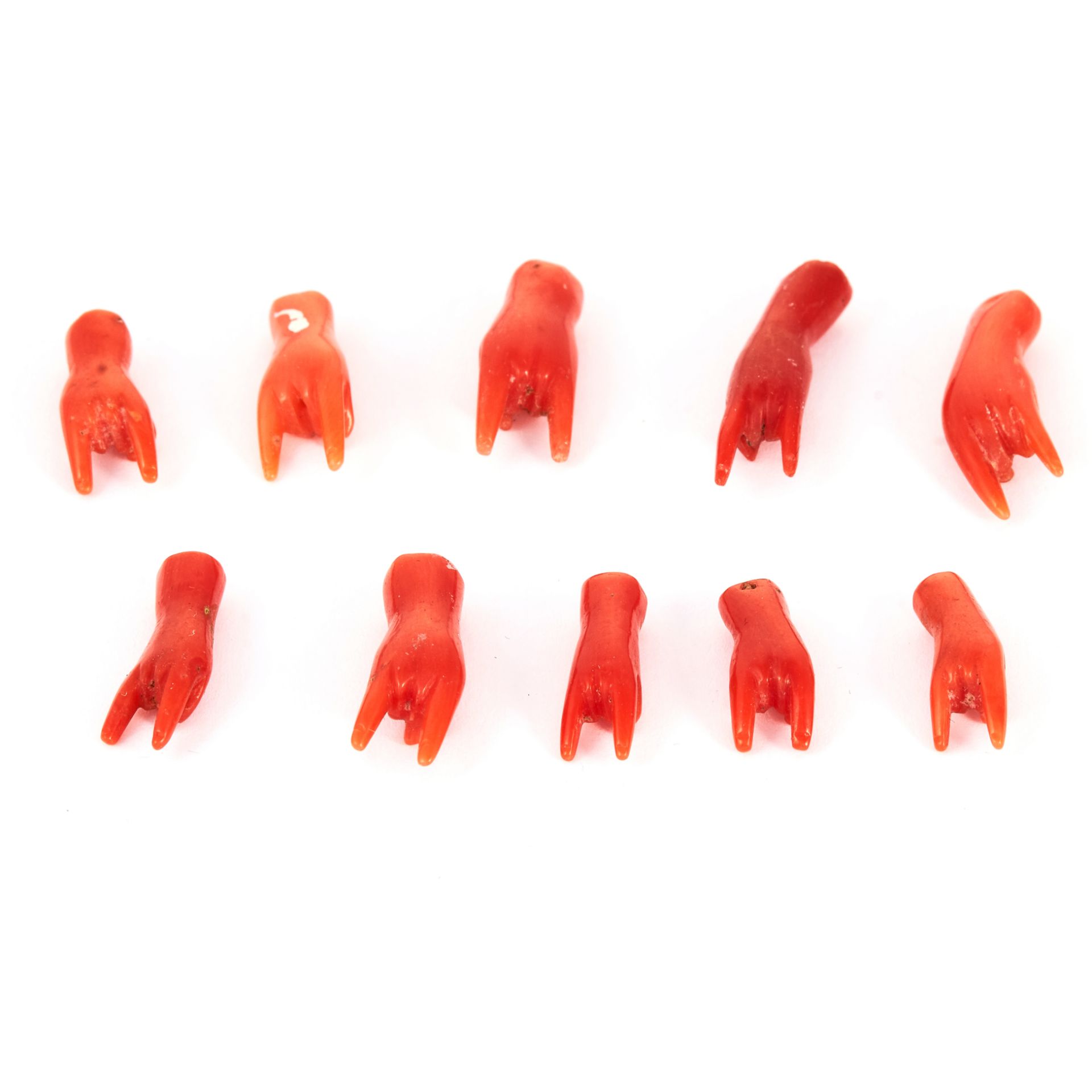 A PARCEL OF 'CORNICELLO' CORAL HANDS depicting good luck symbol, 6.7g.