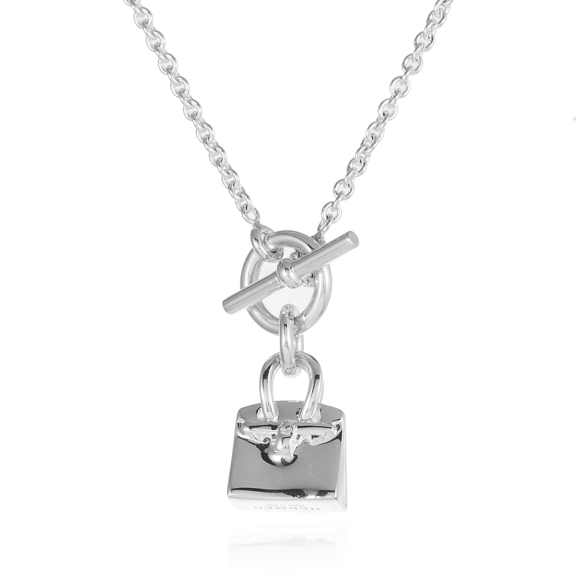 A KELLY BAG AMULETTE PENDANT AND CHAIN, HERMES in sterling silver, designed as chain suspending a