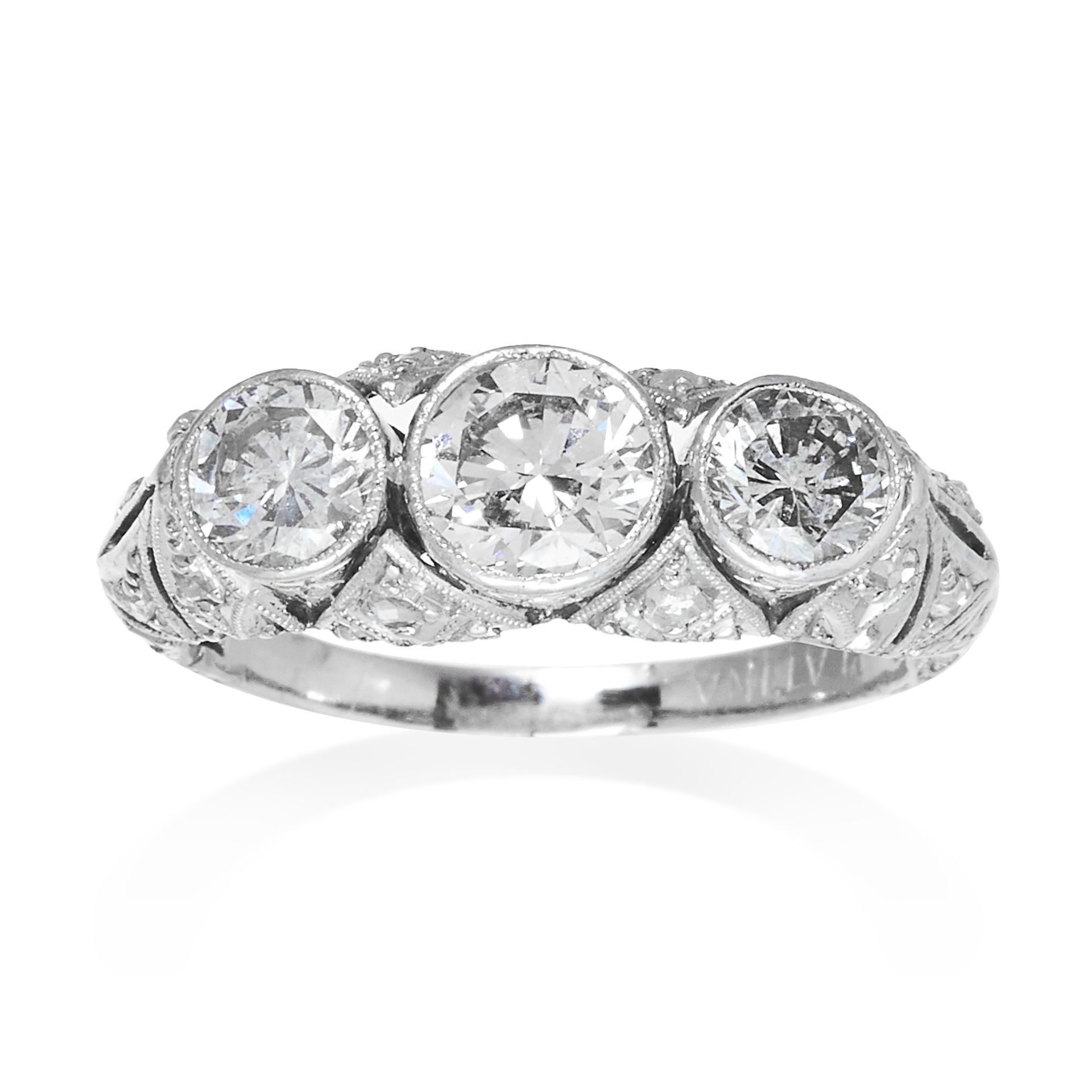 AN ART DECO DIAMOND DRESS RING in platinum, the trio of graduated round cut diamonds totalling 1.