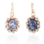 A PAIR OF ANTIQUE SAPPHIRE AND DIAMOND EARRINGS in yellow gold and silver, each with a cabochon