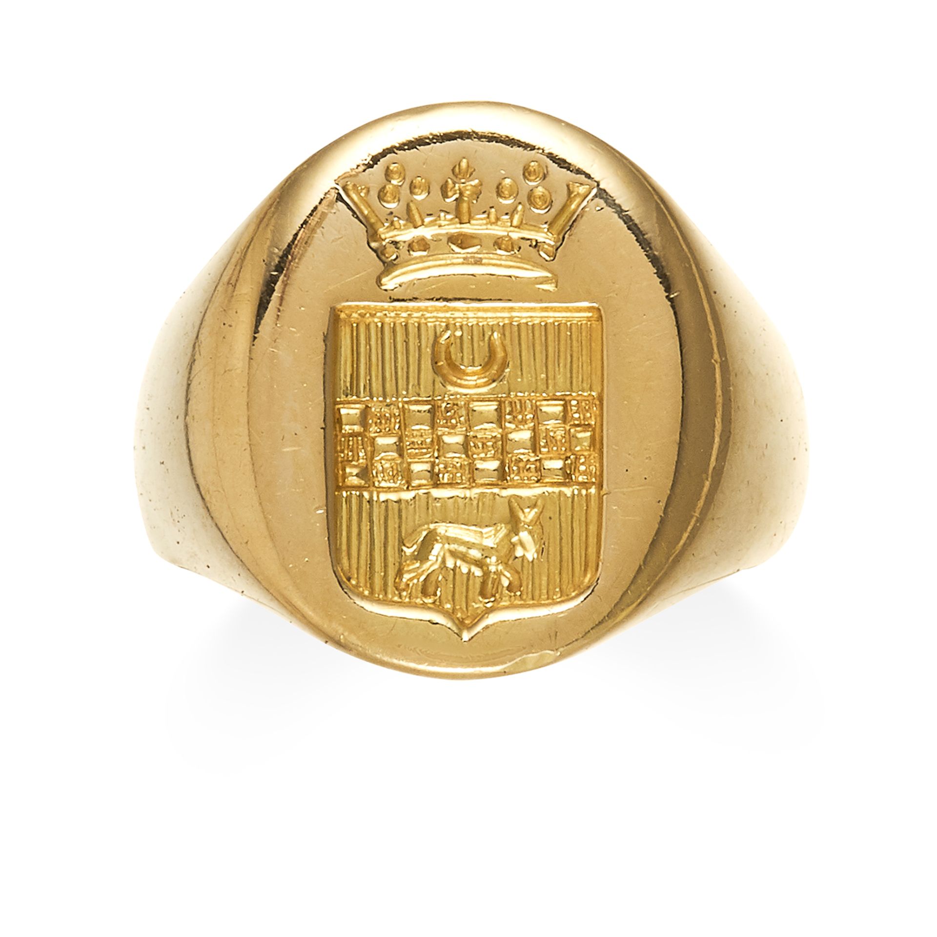AN INTAGLIO SEAL SIGNET RING in high carat yellow gold, the oval face with a reverse engraved coat