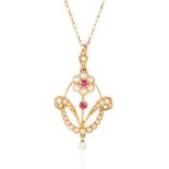 AN ANTIQUE PEARL AND RUBY PENDANT in 15 carat yellow gold gold, comprising of floral motif