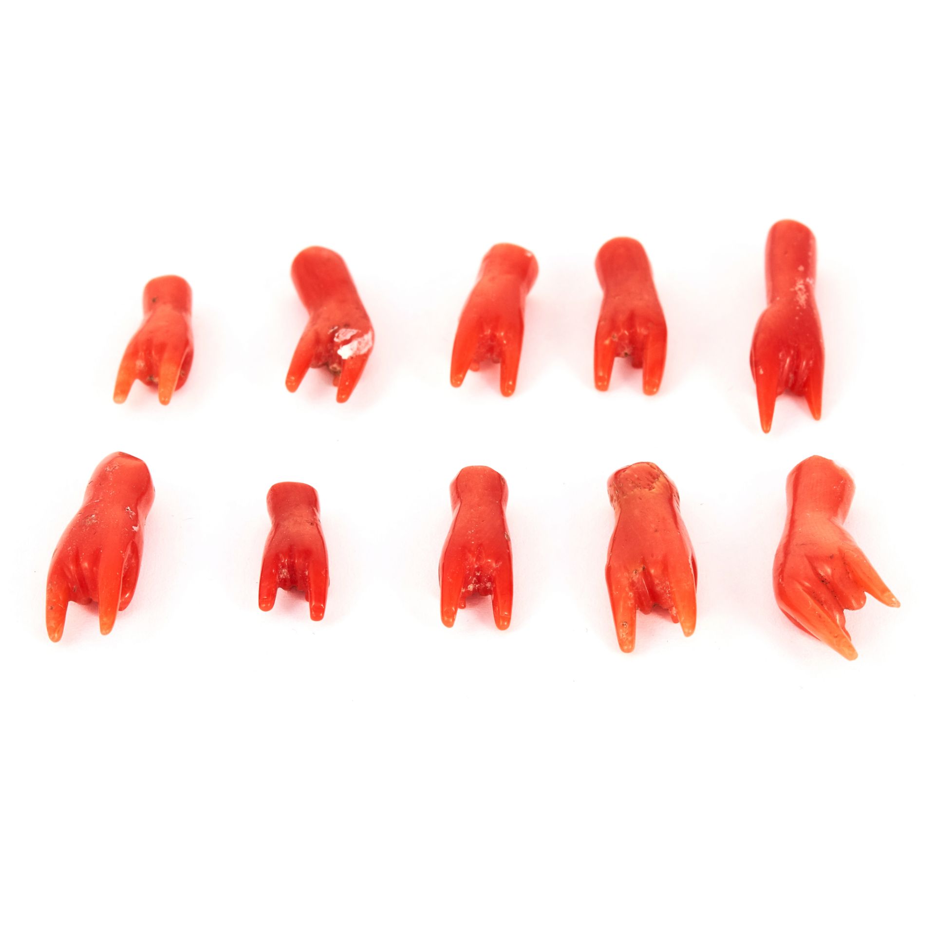 A PARCEL OF 'CORNICELLO' CORAL HANDS depicting good luck symbol, 7.1g.