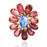 AN CEYLON NO HEAT SAPPHIRE AND TOURMALINE BROOCH in high carat yellow gold, set with an oval cut