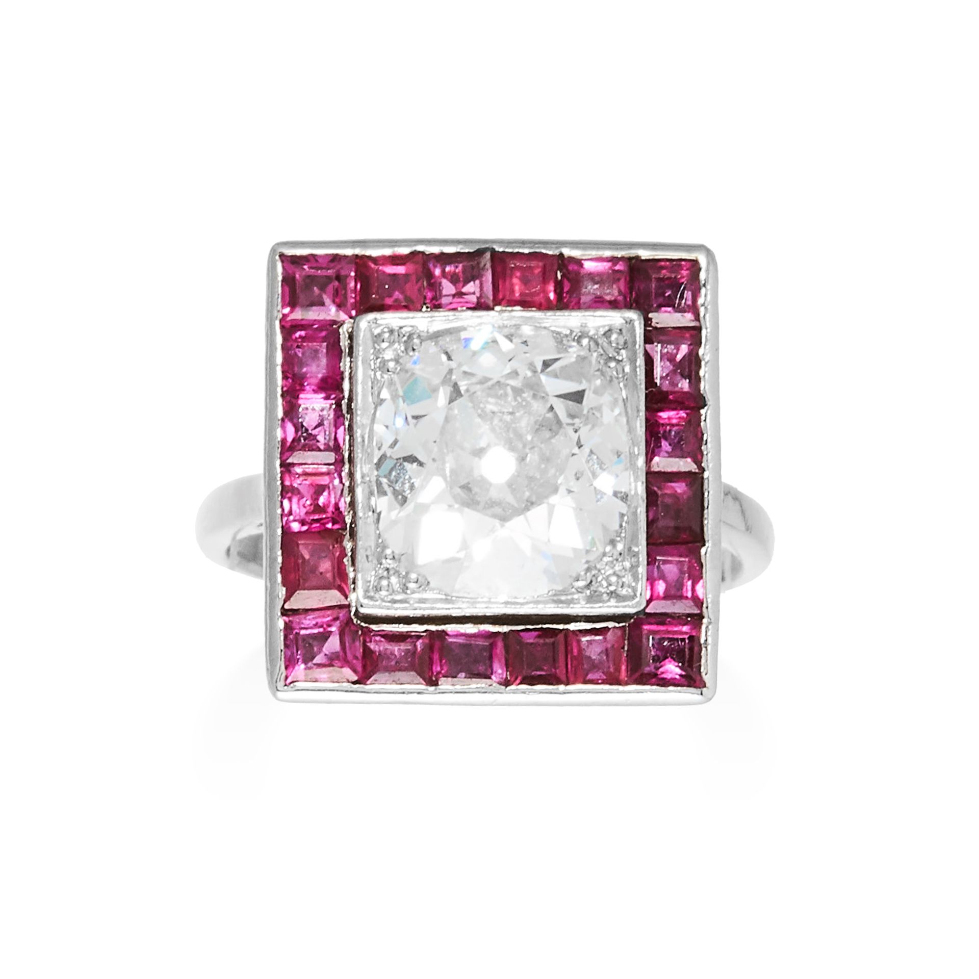 AN ART DECO DIAMOND AND RUBY RING in platinum, set with an old cut diamond, bordered by stepp cut