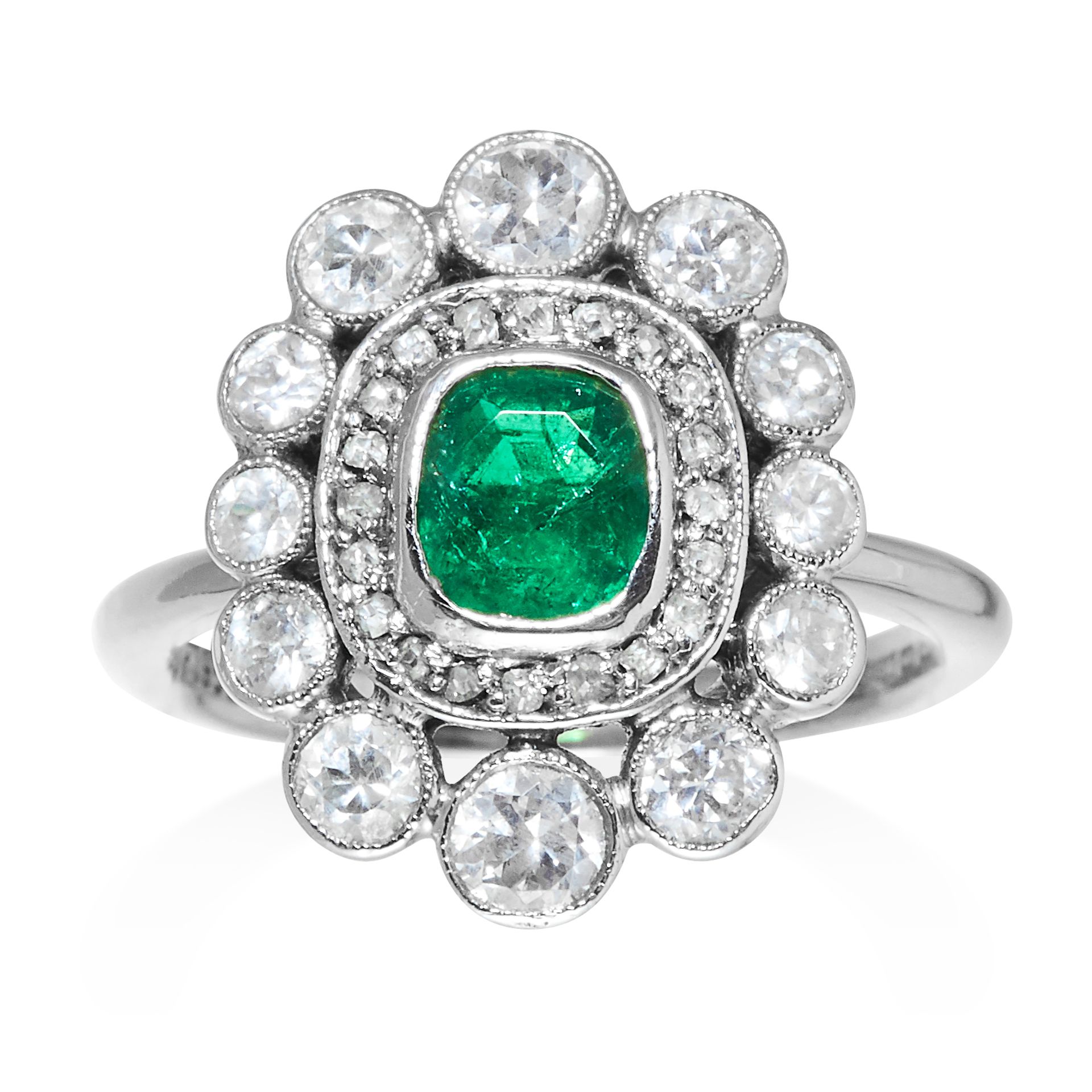 AN EMERALD AND DIAMOND DRESS RING in platinum, jewelled with an oval cut emerald framed in a diamond