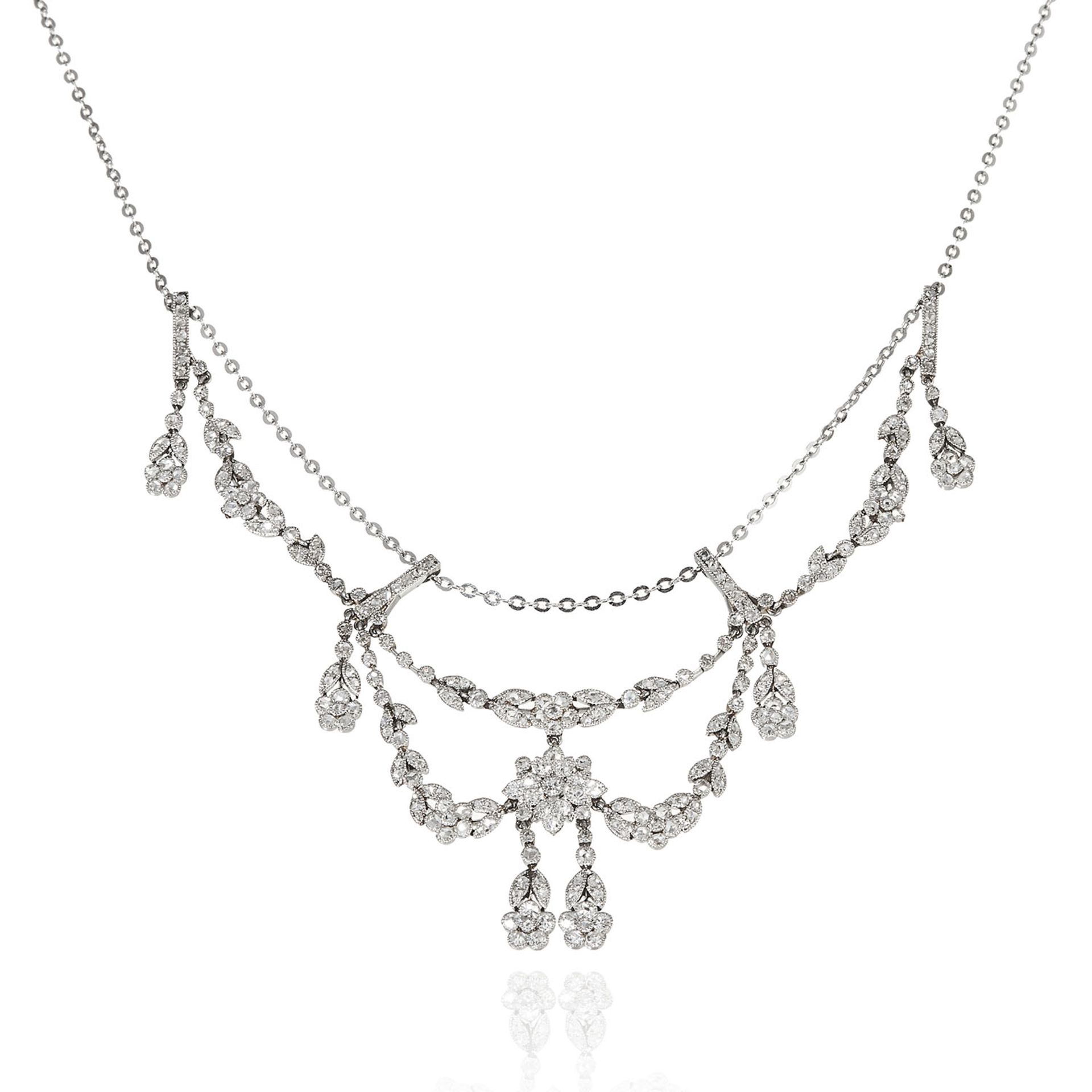 AN ANTIQUE DIAMOND NECKLACE in white gold or platinum, designed in floral and foliate motif,