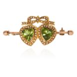 AN ANTIQUE PEARL AND PERIDOT SWEETHEART BROOCH in yellow gold, with ribbon and bow motif jewelled