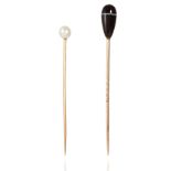 TWO ANTIQUE TIE / STICK PINS in yellow gold, one set with a pearl, the other with a polished