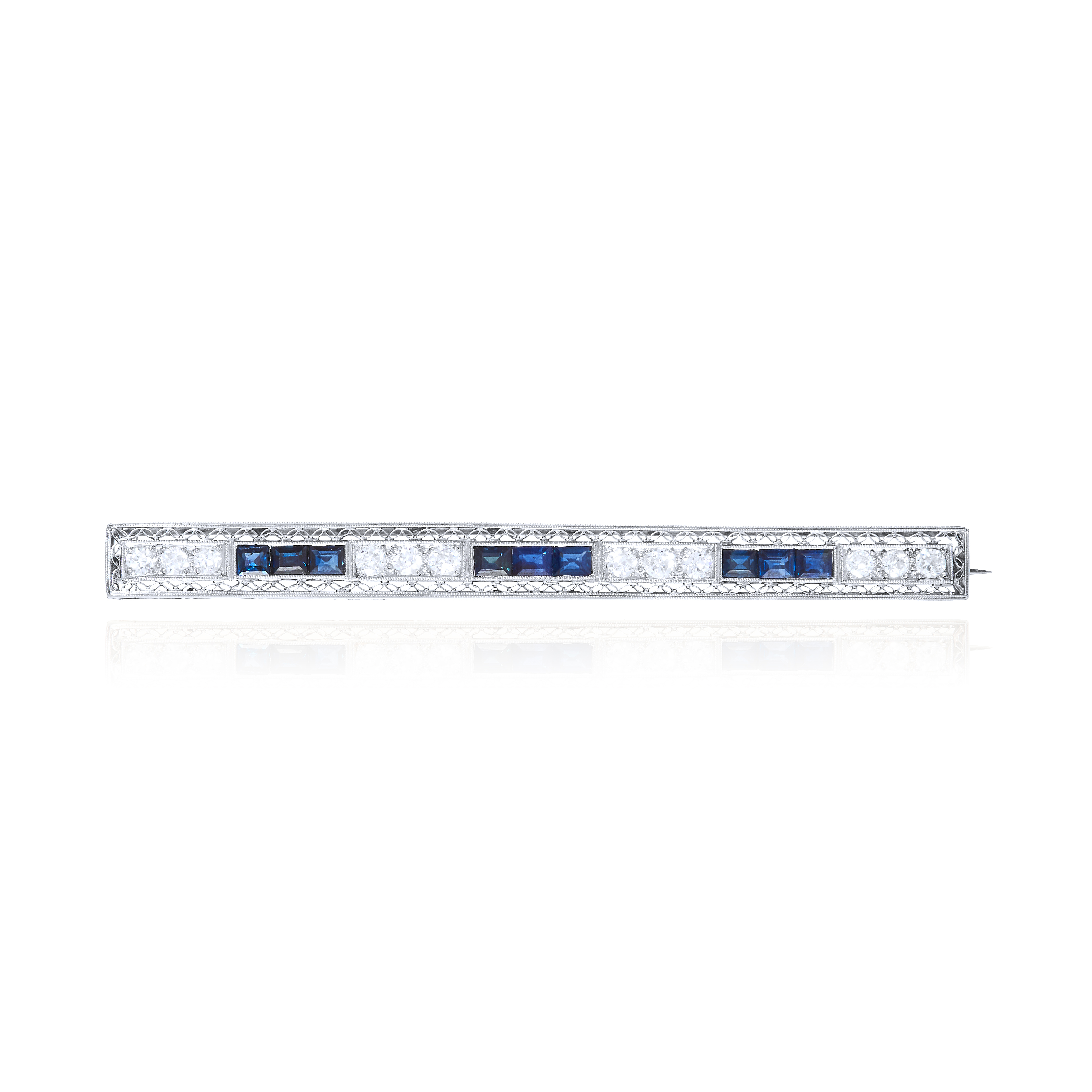 AN ART DECO SAPPHIRE AND DIAMOND BAR BROOCH in platinum or white gold, set with alternating trios of