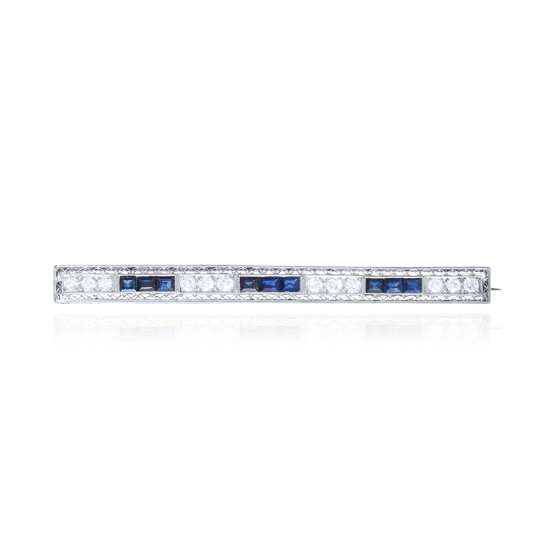 AN ART DECO SAPPHIRE AND DIAMOND BAR BROOCH in platinum or white gold, set with alternating trios of