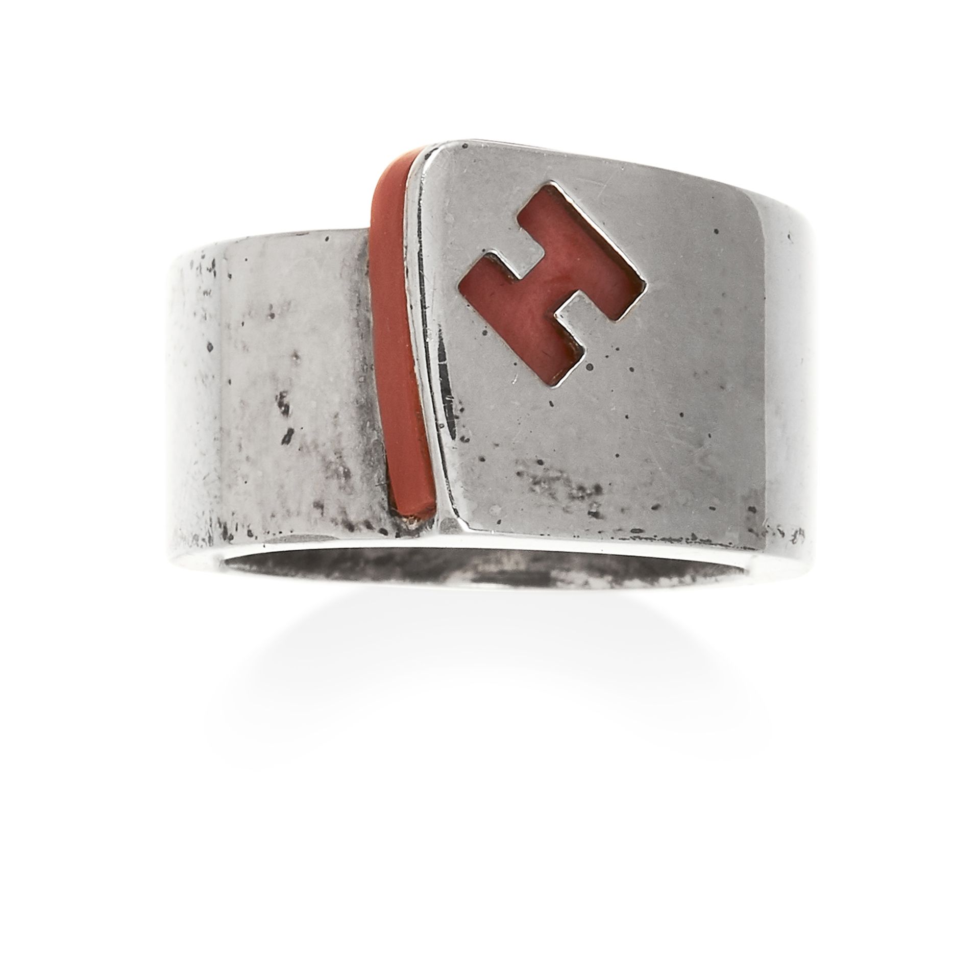 A CORAL 'CANDY' RING, HERMES in sterling silver, the coral plate is overlapped by 'H' imprint,