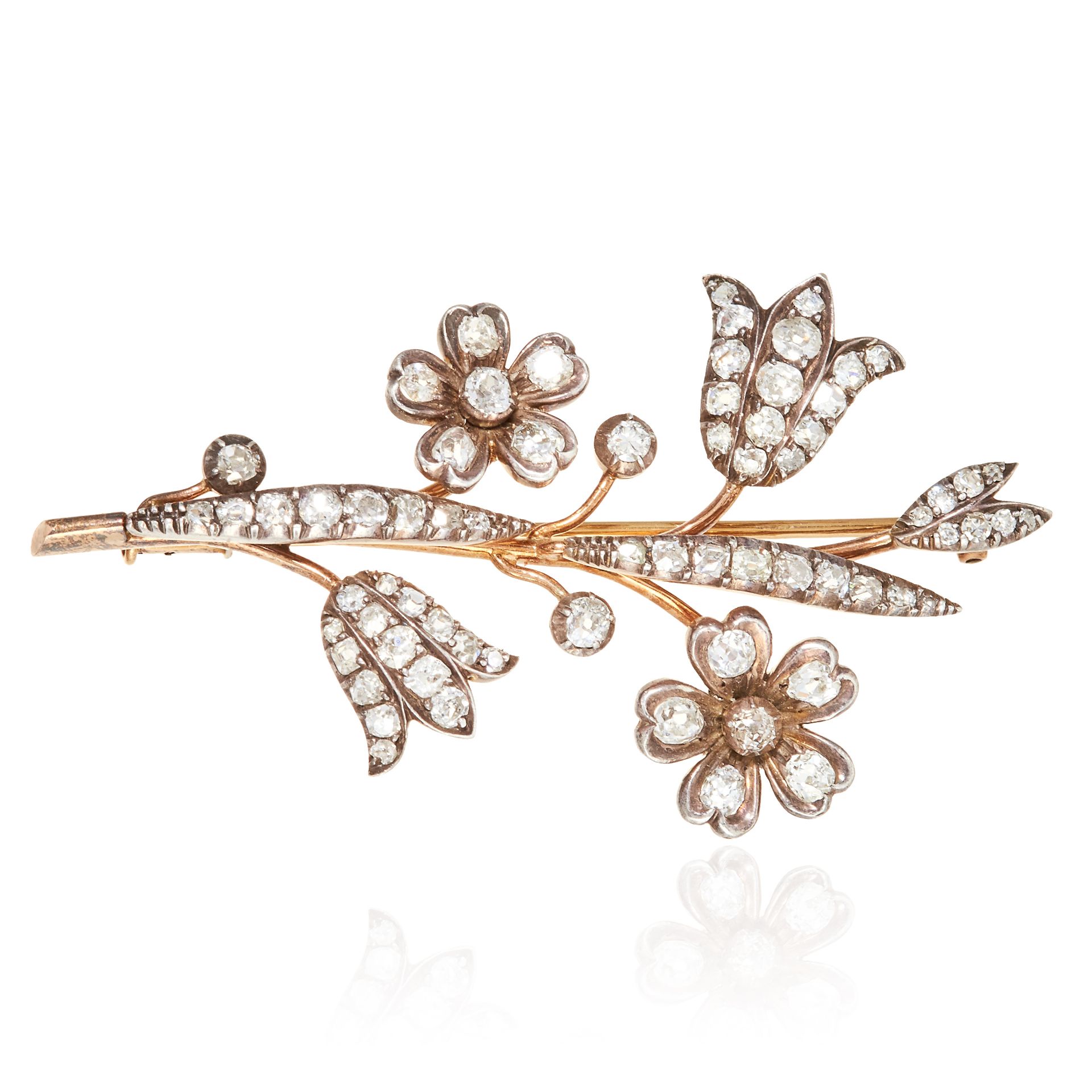 A DIAMOND FLOWER SPRAY BROOCH in gold or silver, designed as floral spray jewelled with old cut
