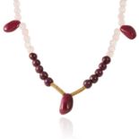 A RUBY, ROSE QUARTZ AND DIAMOND NECKLACE in 14ct yellow gold, comprising of a single row of polished