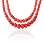 A CORAL BEAD NECKLACE in 18ct yellow gold, the two rows of graduated, polished beads up to 14.3mm on